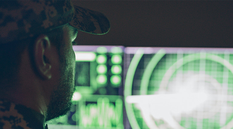 An Army soldier at a computer screen